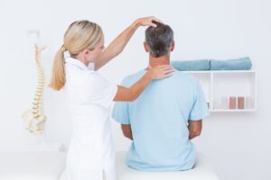 Chiropractor studying person's neck and posture
