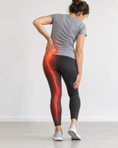 Woman experiencing sciatica pain in the lower back and leg